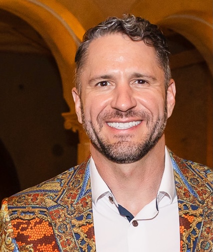 Brantley Beaird smiling in a patterned jacket